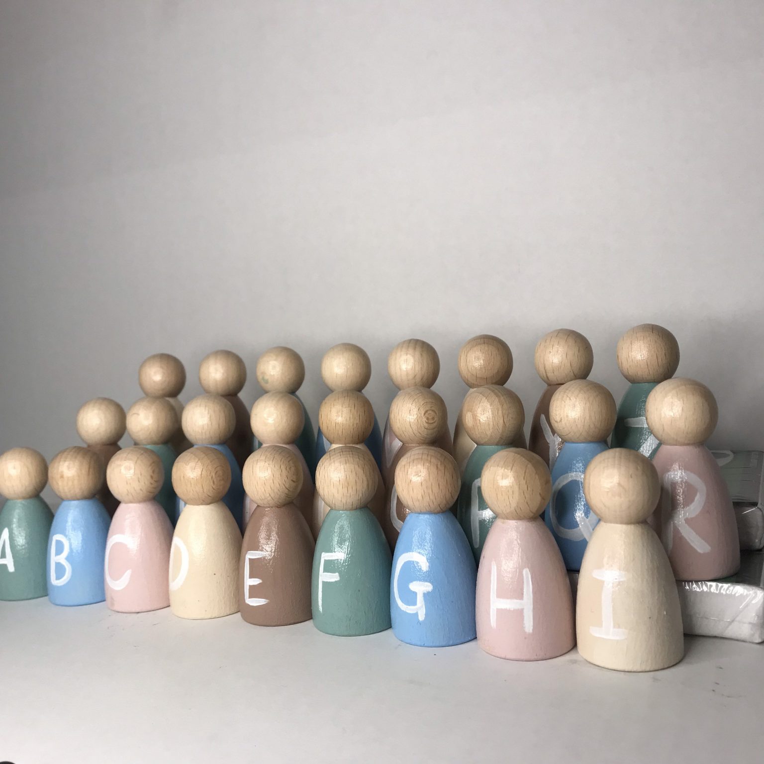 Wooden alphabet peg dolls